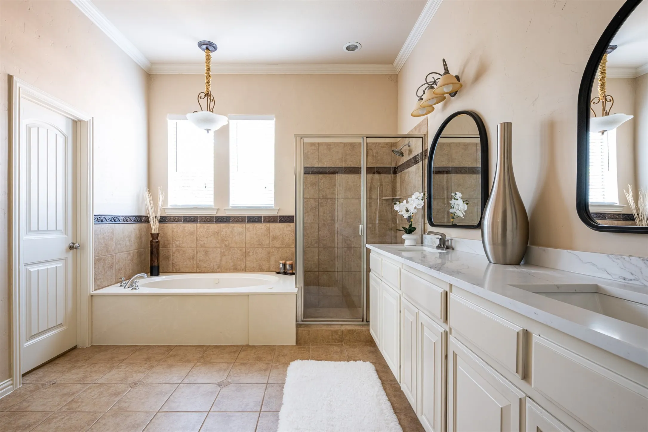 Primary Ensuite Bath with dual vanities, spacious His and Hers individual Walk-In Closets