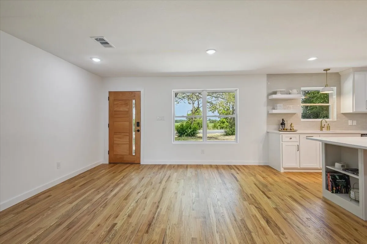 Unfurnished dining area featuring light wood-style flooring and recessed lighting