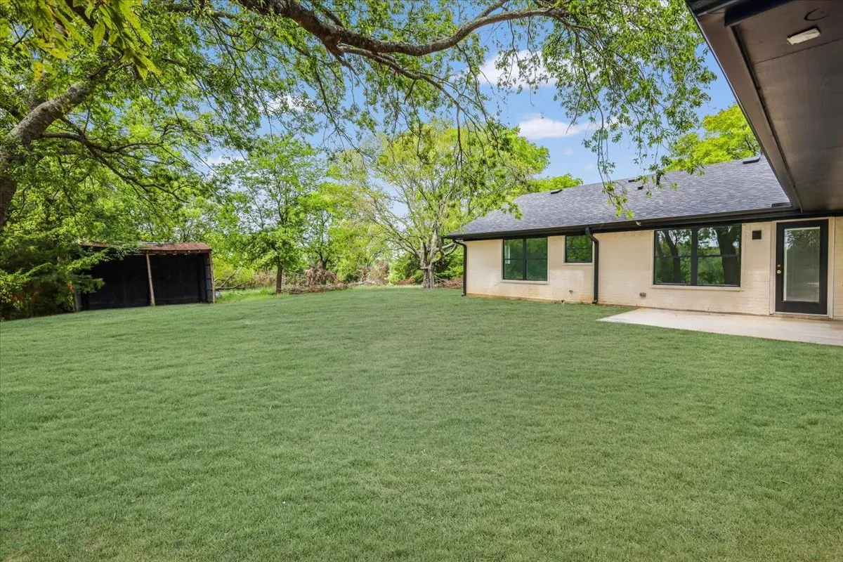 View of grassy yard with a patio