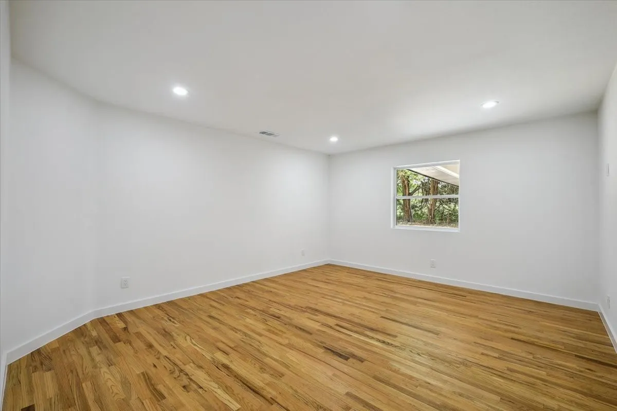 Unfurnished room with light wood finished floors and recessed lighting