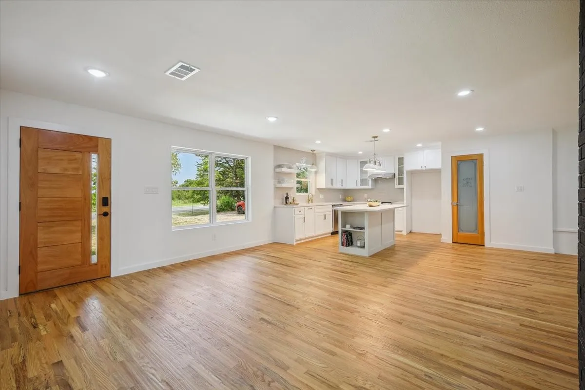 Unfurnished living room with light wood finished floors and recessed lighting