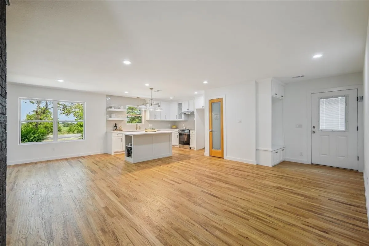 Unfurnished living room with light wood-type flooring and recessed lighting