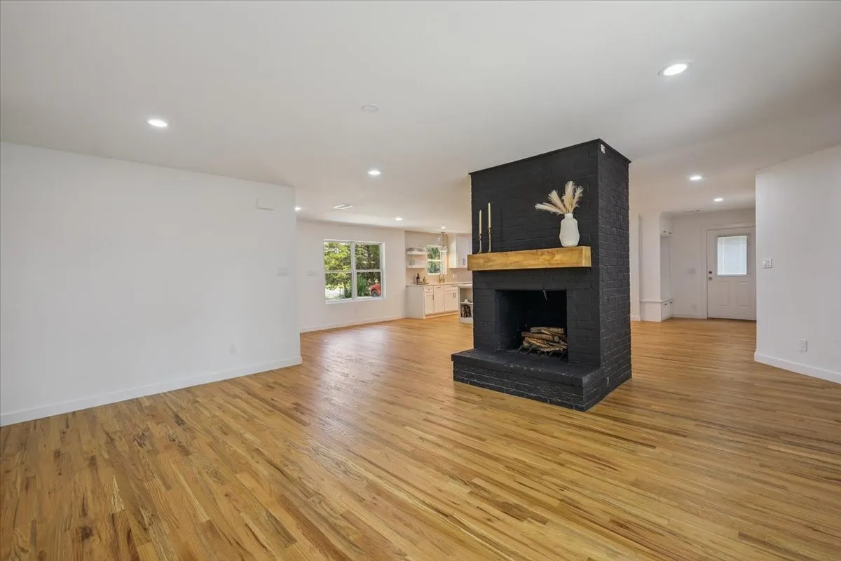 Unfurnished living room with recessed lighting, a fireplace, and light wood finished floors