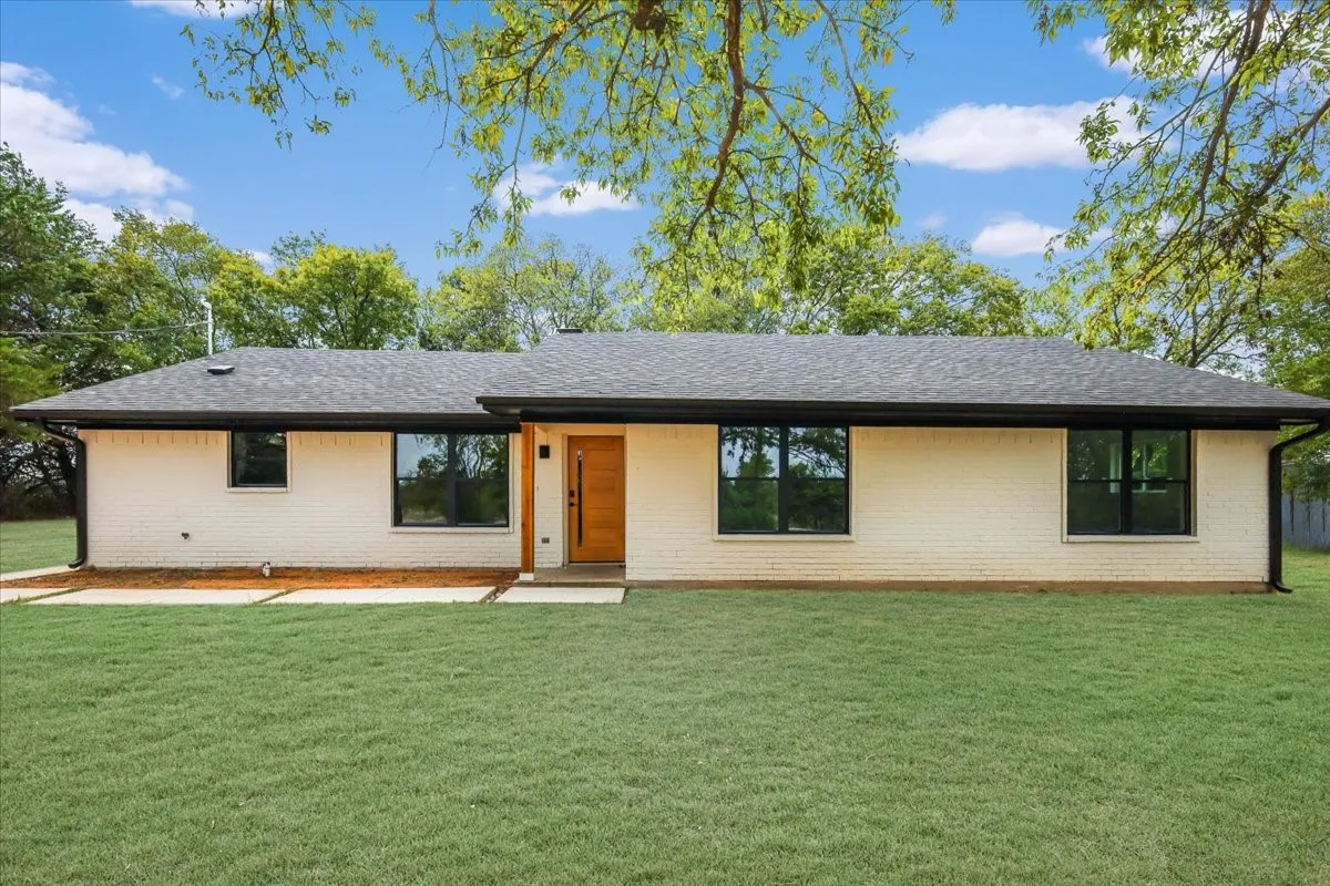 Ranch-style house featuring a front yard and brick siding