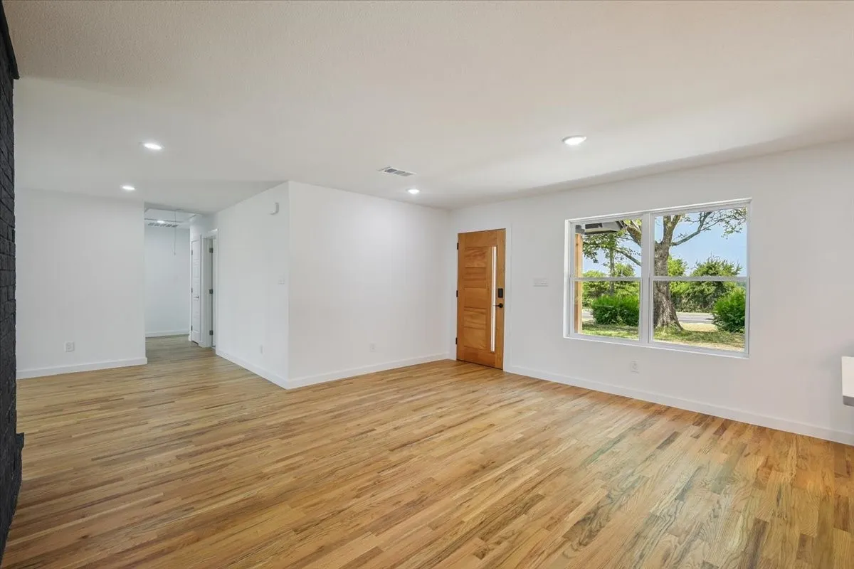 Spare room with light wood-type flooring and recessed lighting