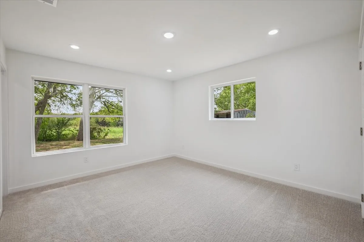 Unfurnished room featuring light colored carpet and recessed lighting