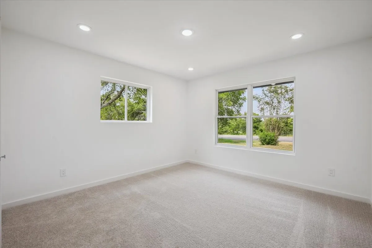 Spare room with recessed lighting and light colored carpet
