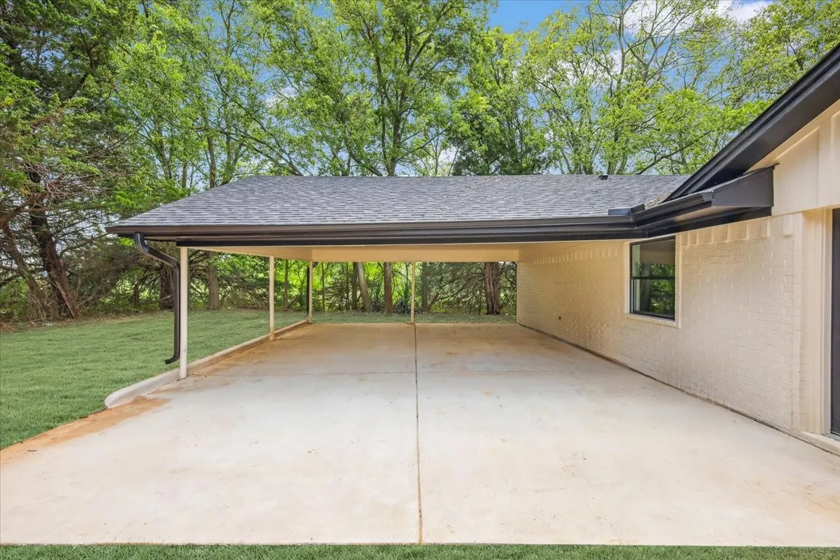 View of patio / terrace featuring a carport and driveway