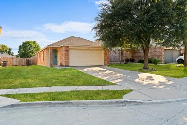 View of front of home with brick siding, concrete driveway, and a garage