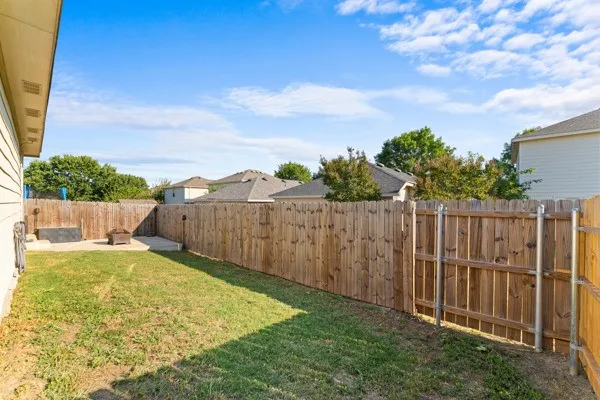 Fenced backyard with a patio area