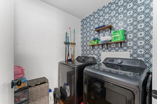 Washroom with washer and clothes dryer