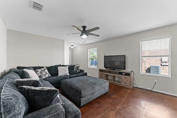 Living room with ceiling fan and baseboards