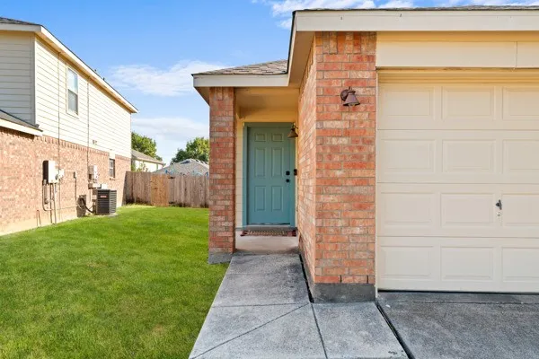 Property entrance with brick siding and a garage