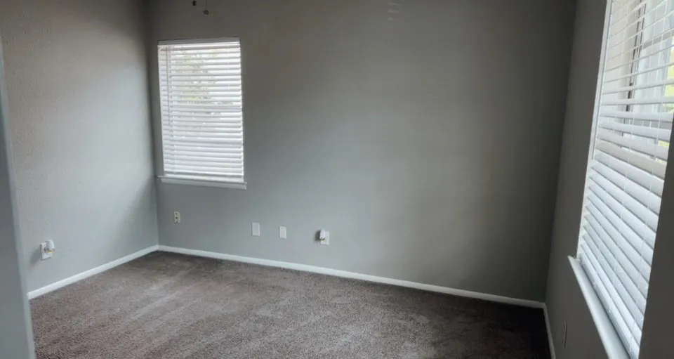 Carpeted 3rd bedroom with a wealth of natural light