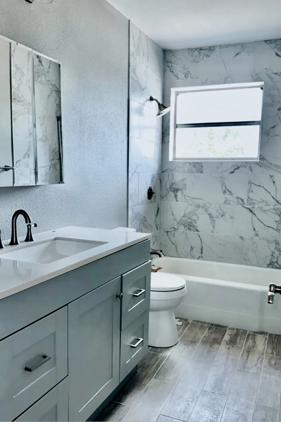 Full bathroom featuring toilet, vanity, and tiled shower / bath
