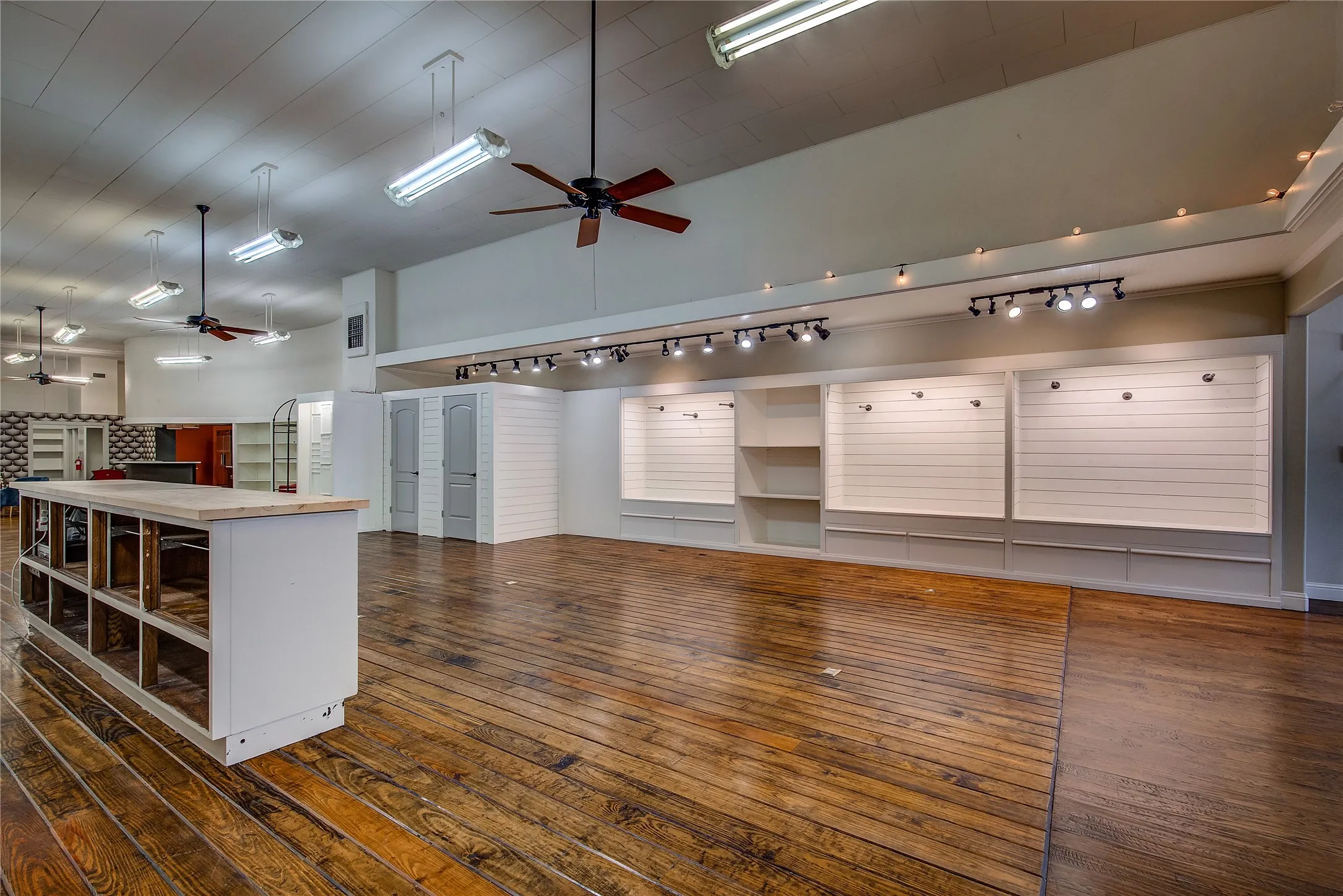 Display areas have painted wooden backing. The overhang is finished with beadboard.