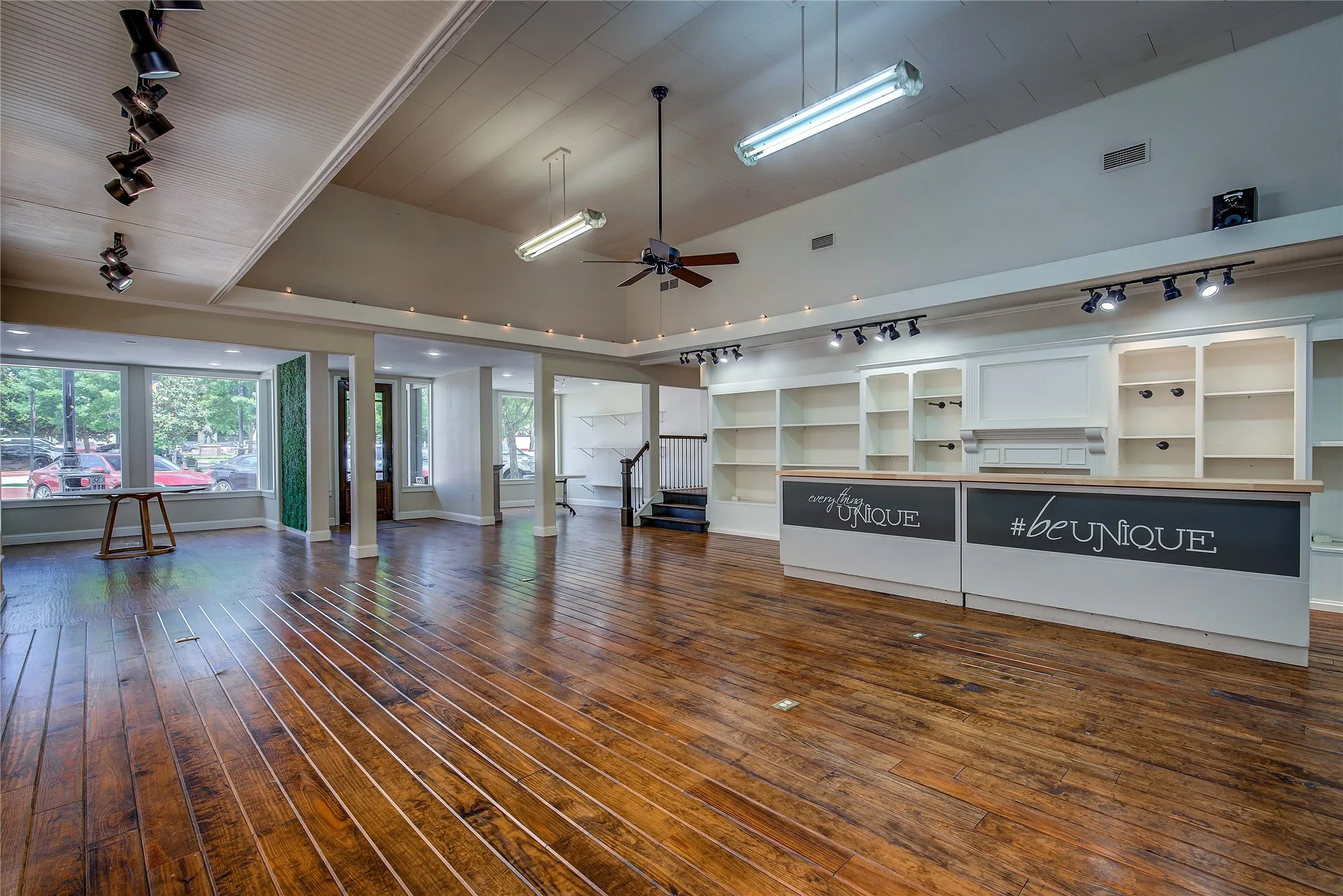 Large checkout counter with wooden built-in display cases behind.