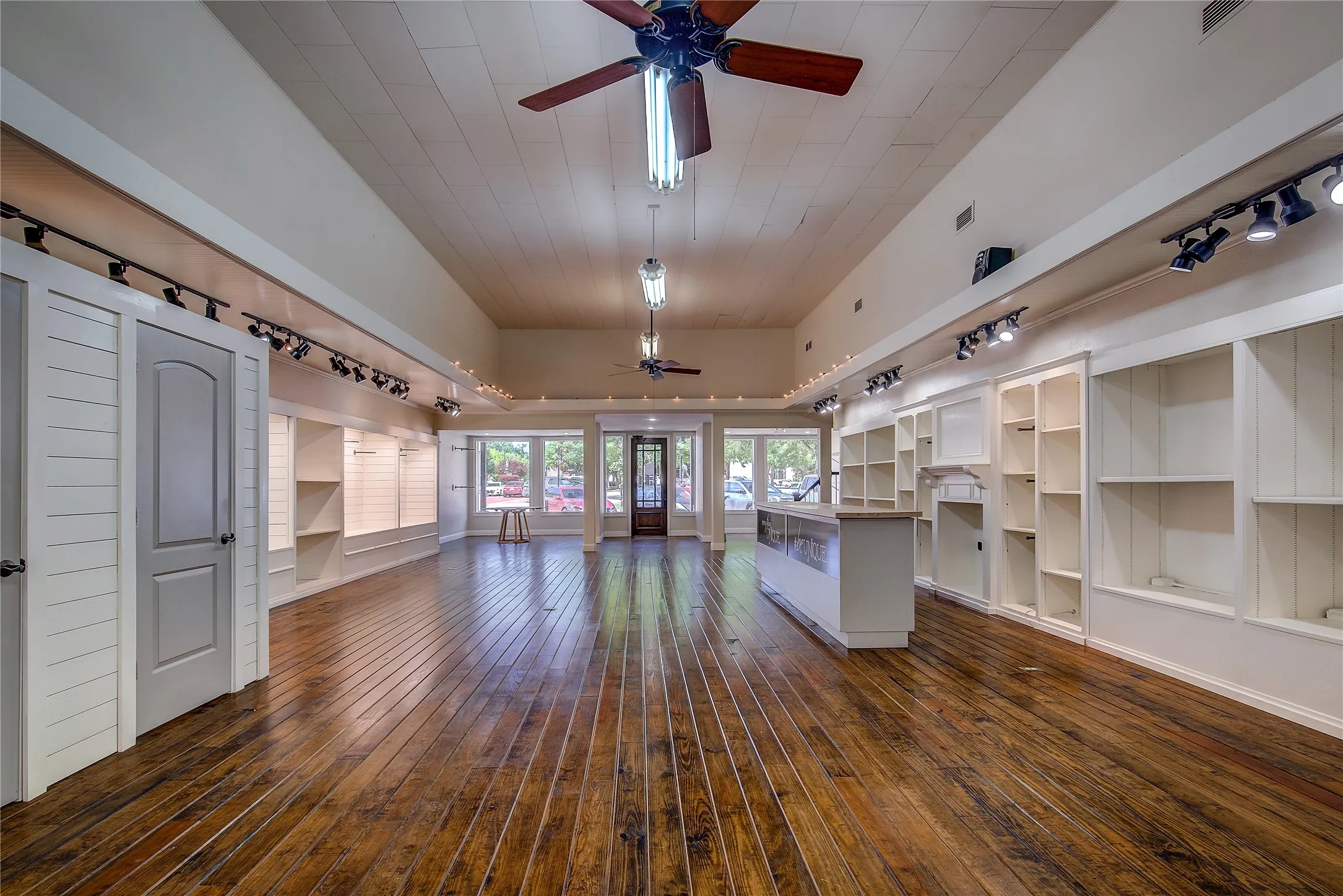 Built-in shelving units with track lighting make beautiful display cases down both sides of the store.