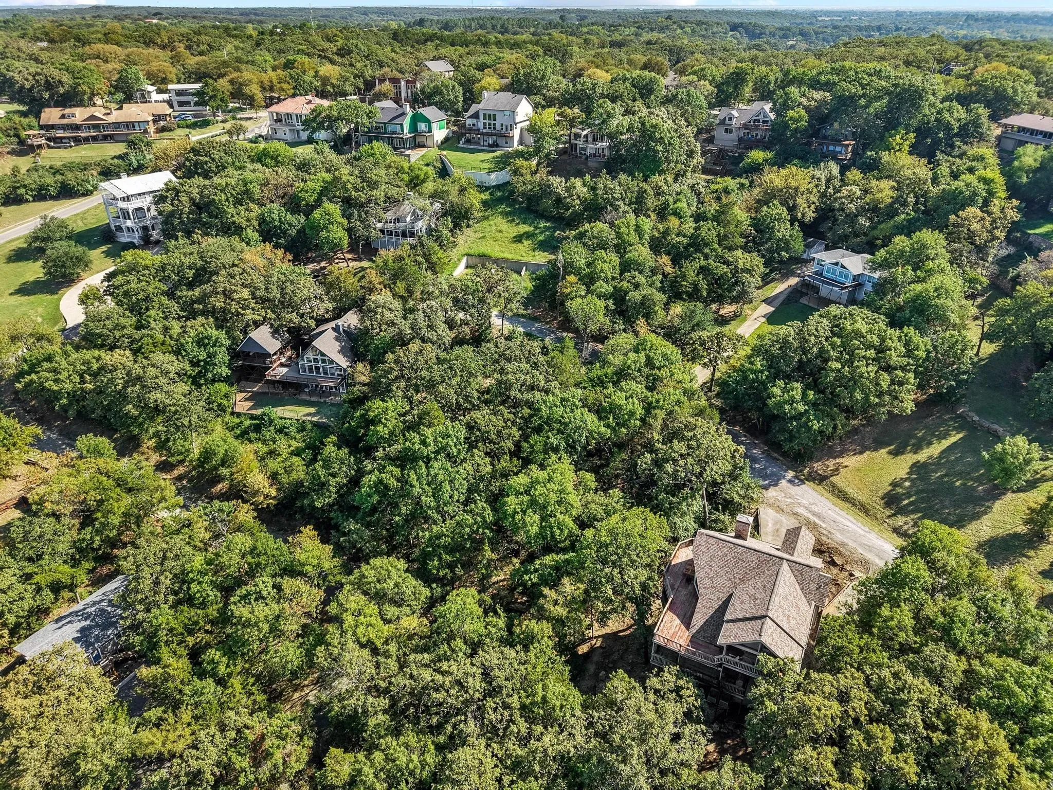 Aerial view of property and surrounding area featuring a heavily wooded area