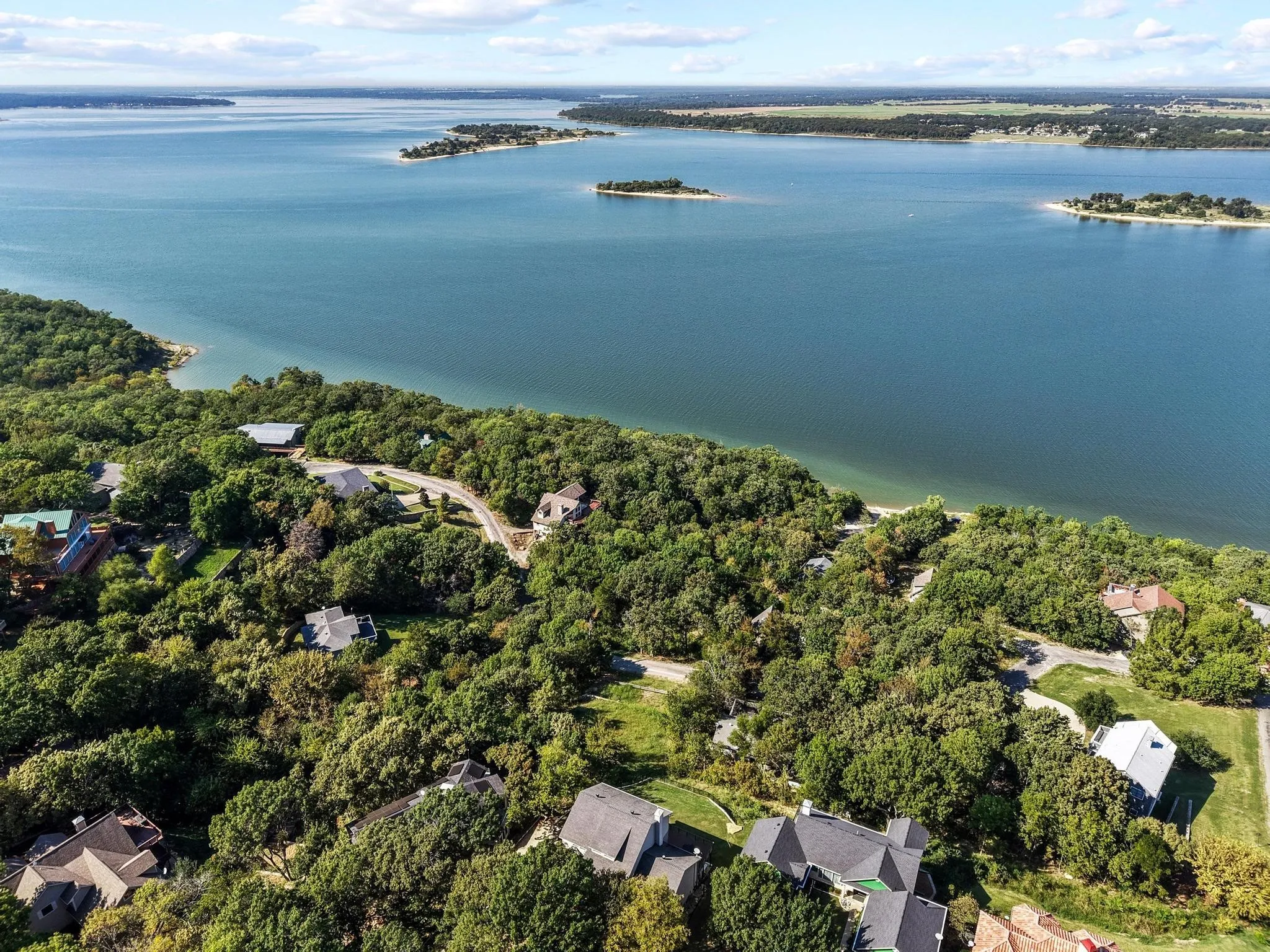 Aerial view of property and surrounding area with a large body of water and nearby suburban area