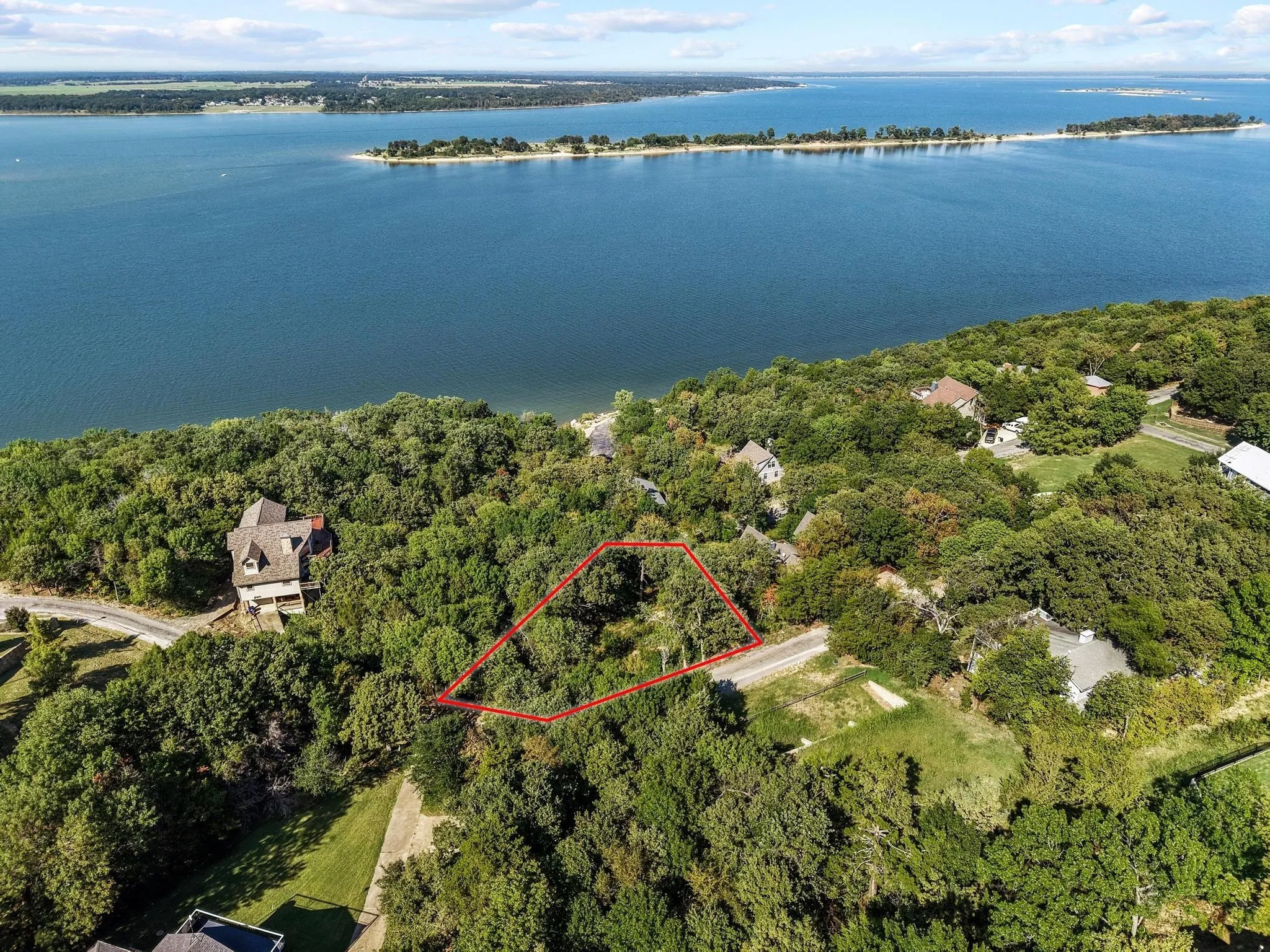 Aerial overview of property's location featuring property boundaries highlighted and a large body of water