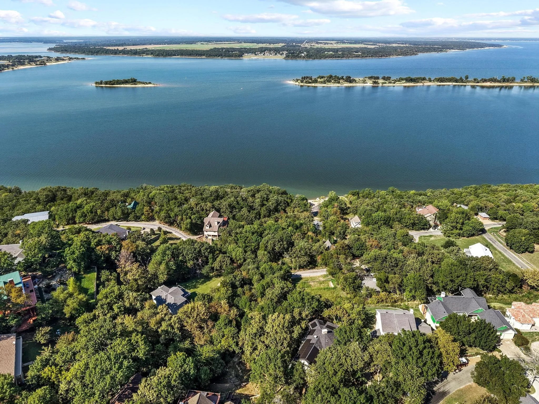 Aerial overview of property's location with a nearby body of water and nearby suburban area