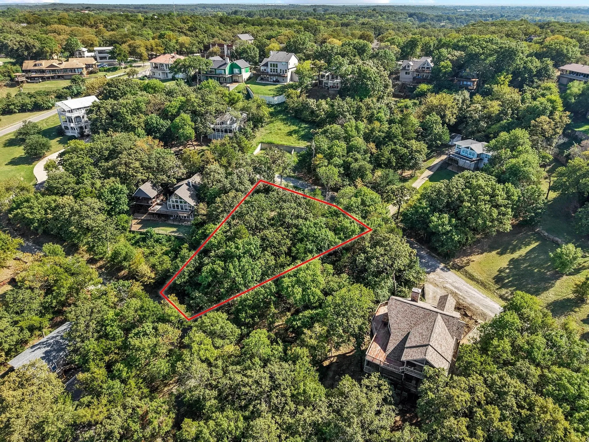 Aerial view of property and surrounding area with a forest and property parcel outlined