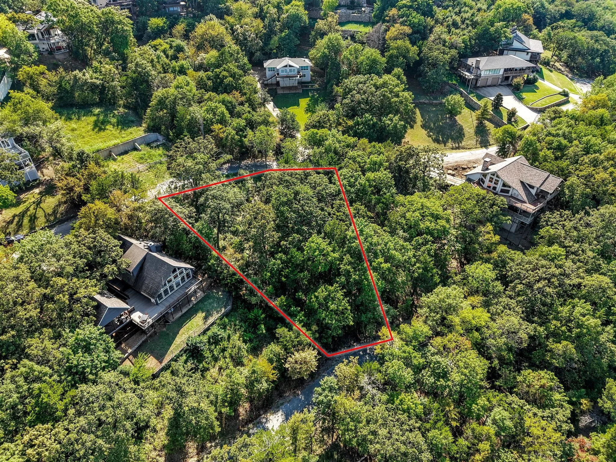 Aerial overview of property's location featuring a forest and property parcel outlined
