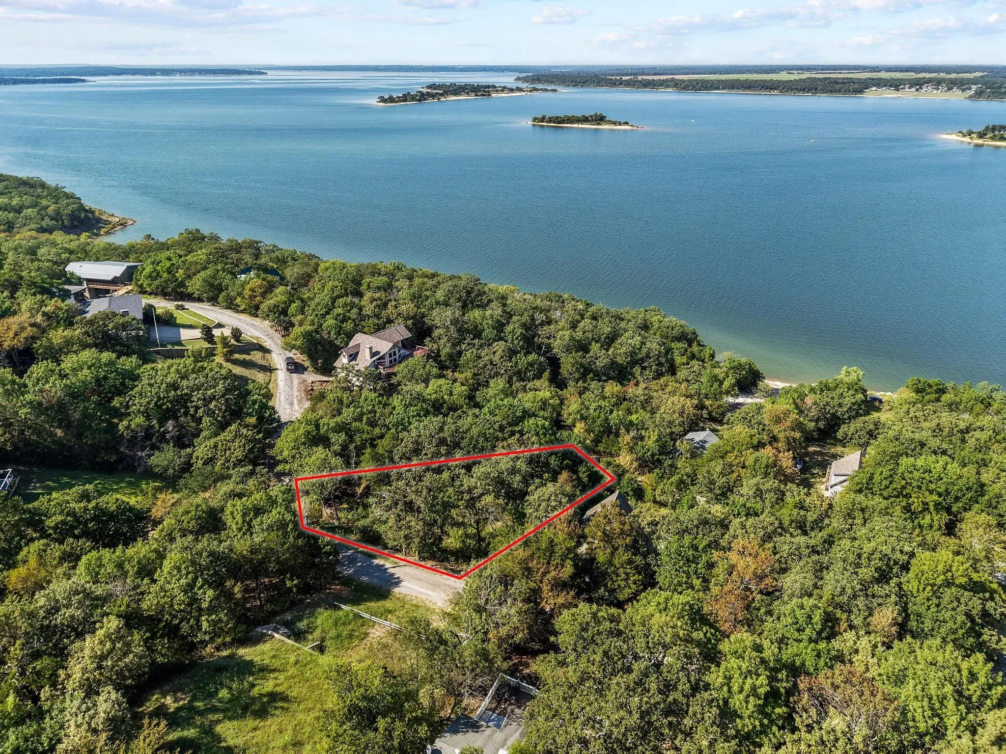 Aerial view of property's location with property boundaries highlighted and a nearby body of water
