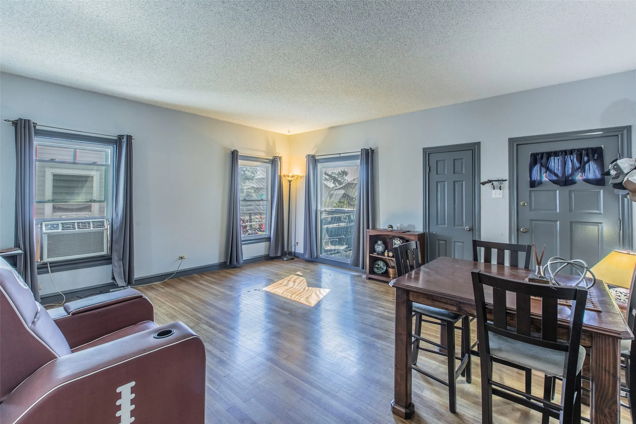 Living area featuring a textured ceiling and wood finished floors