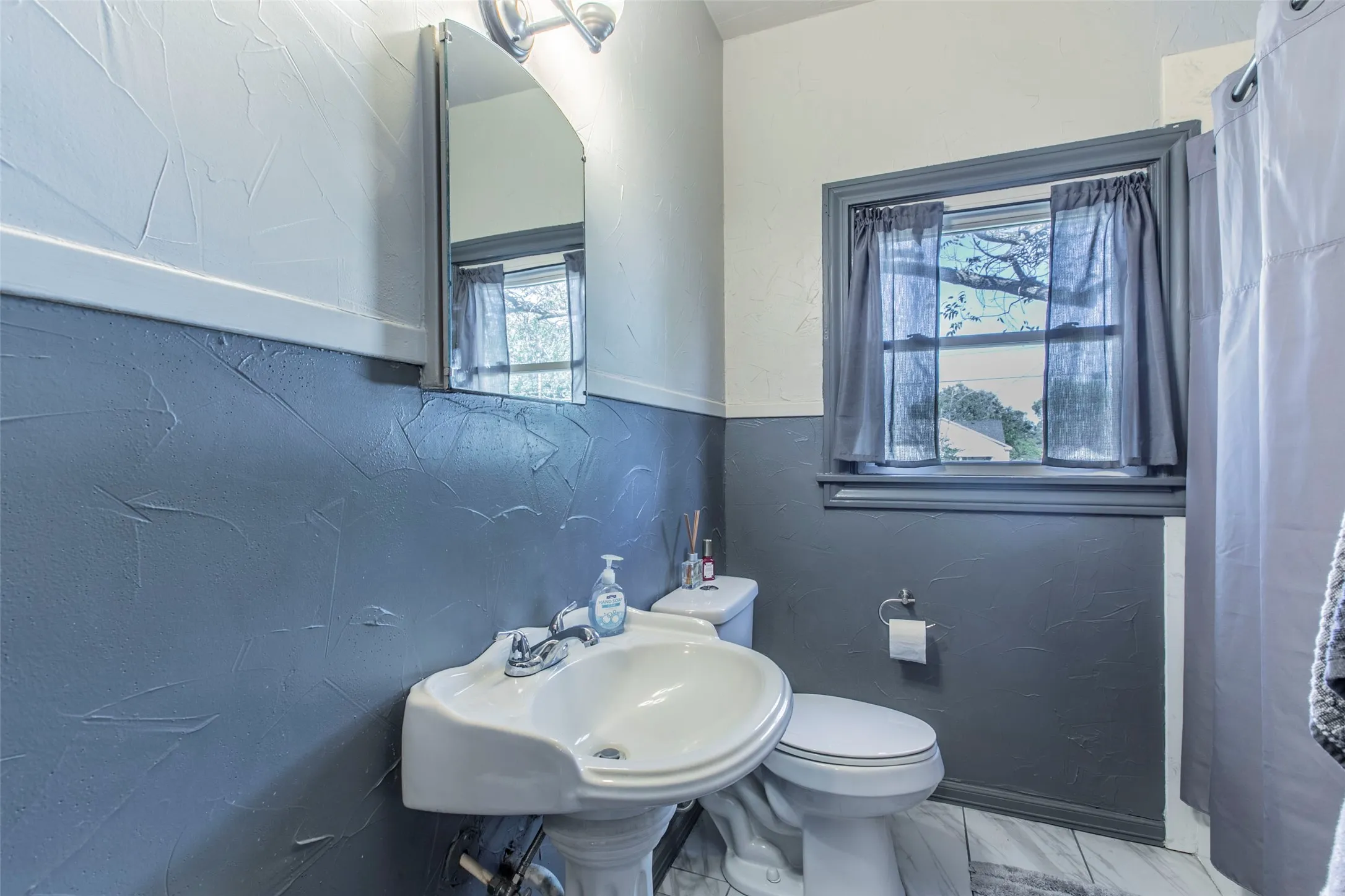 Bathroom with toilet and a textured wall