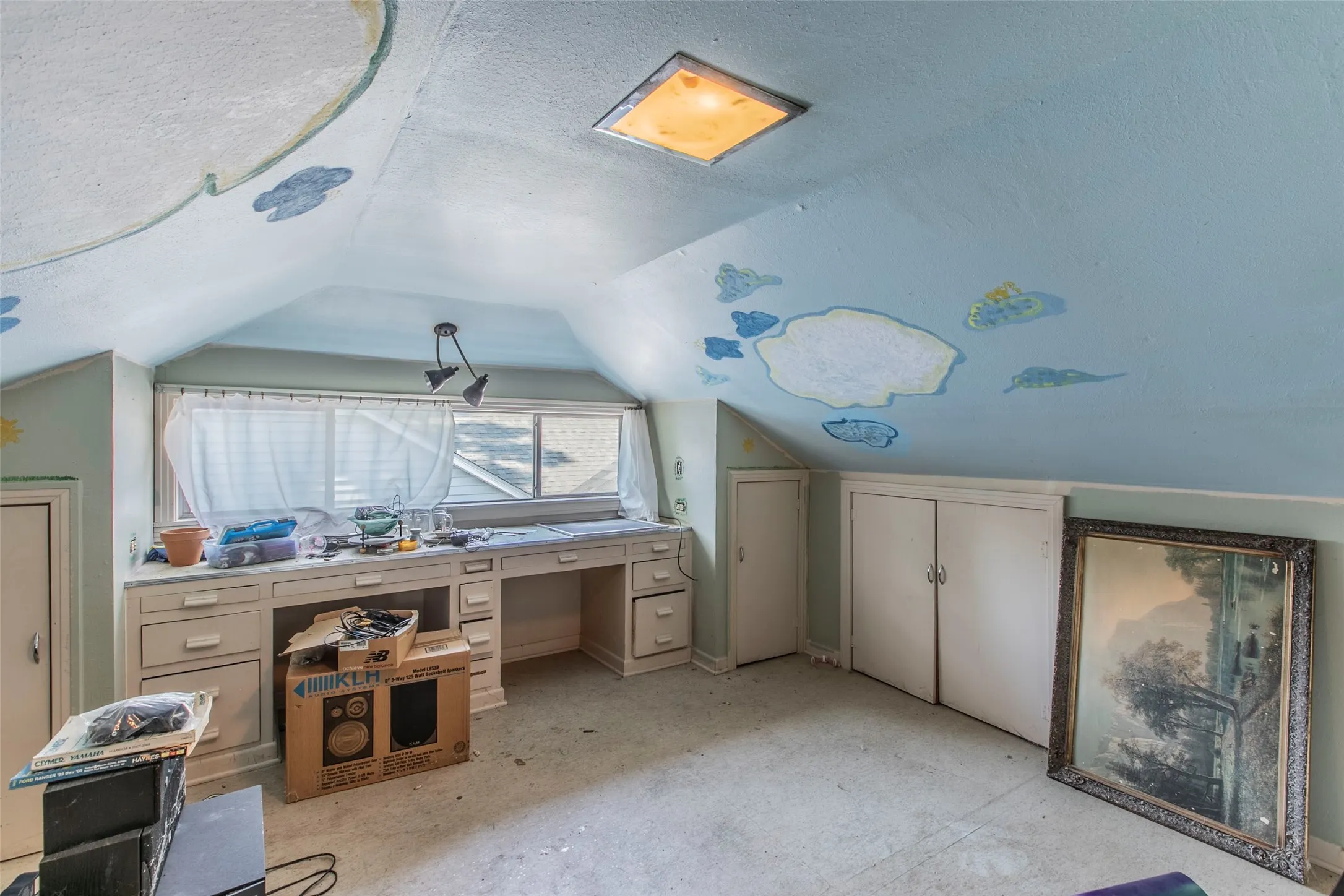 Office with lofted ceiling and a textured ceiling