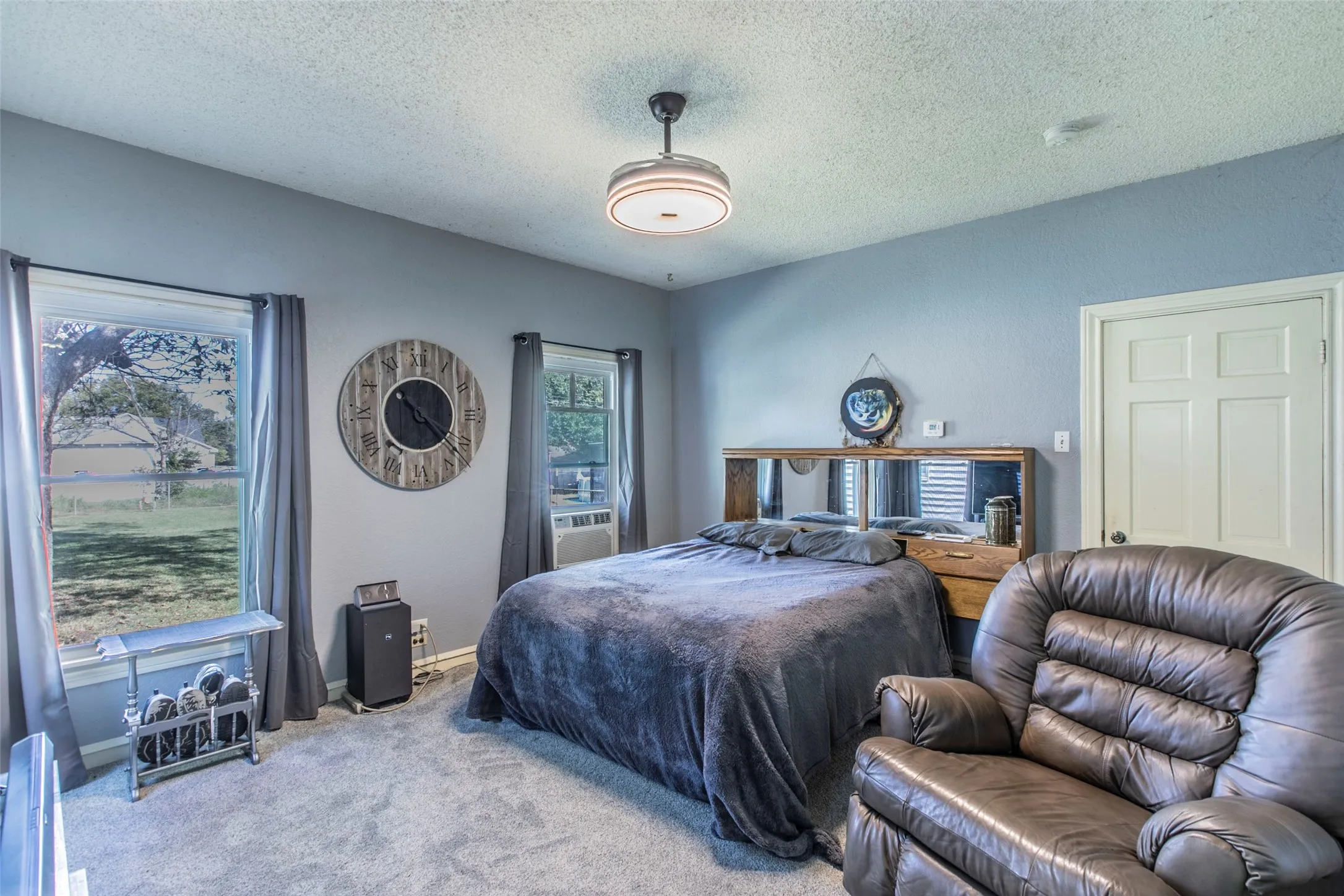 Bedroom with a textured ceiling and carpet