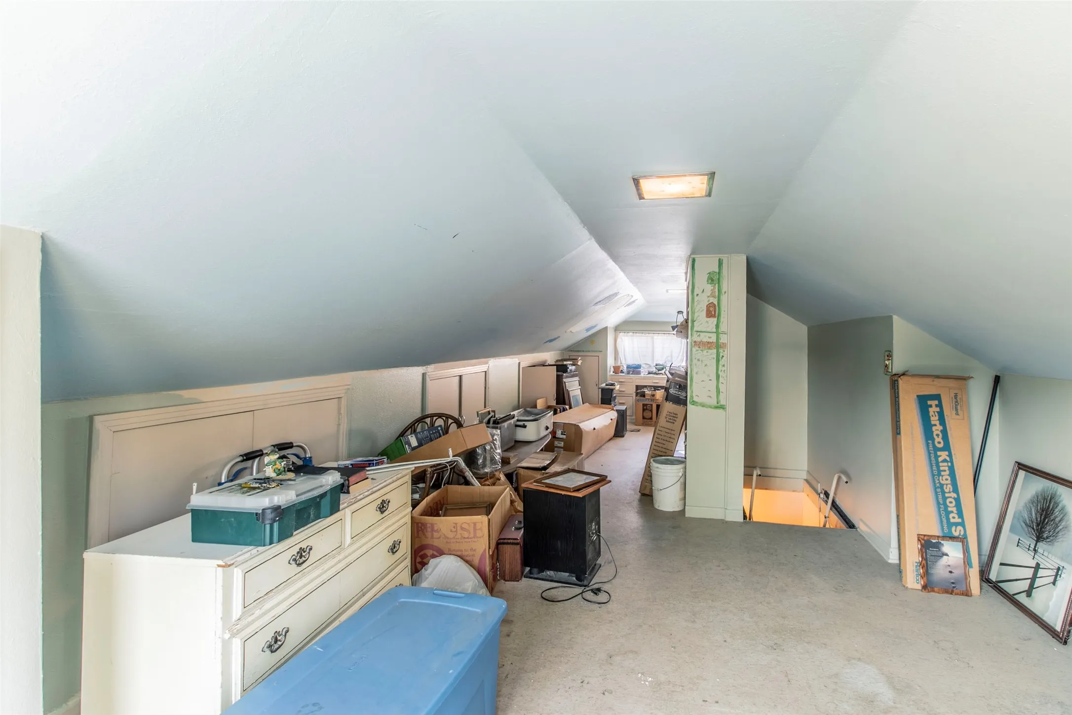 Bonus room featuring lofted ceiling and concrete floors