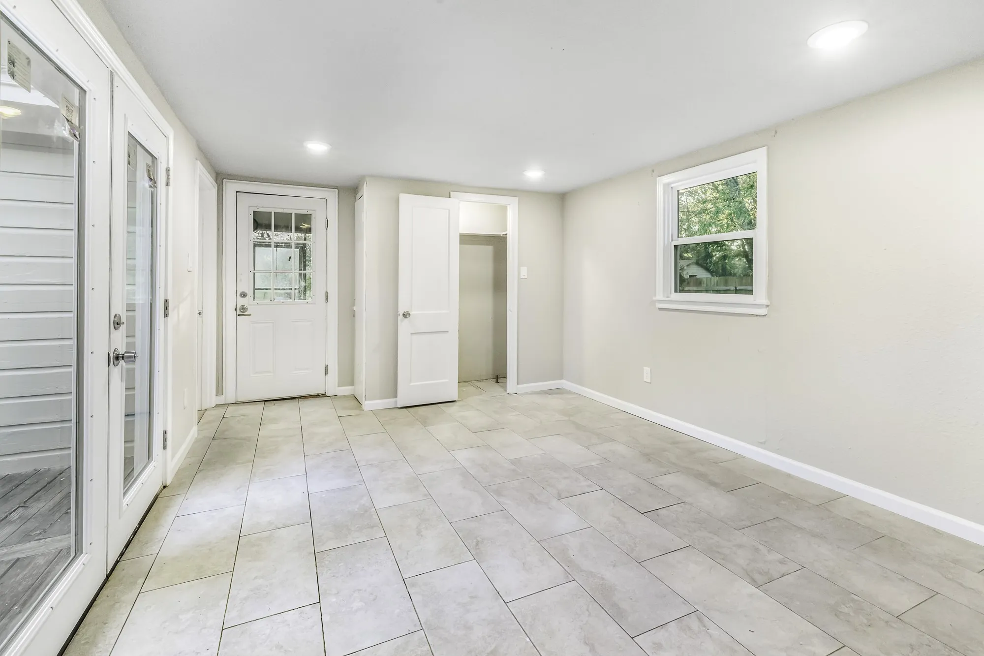 Empty room featuring recessed lighting and light tile patterned floors