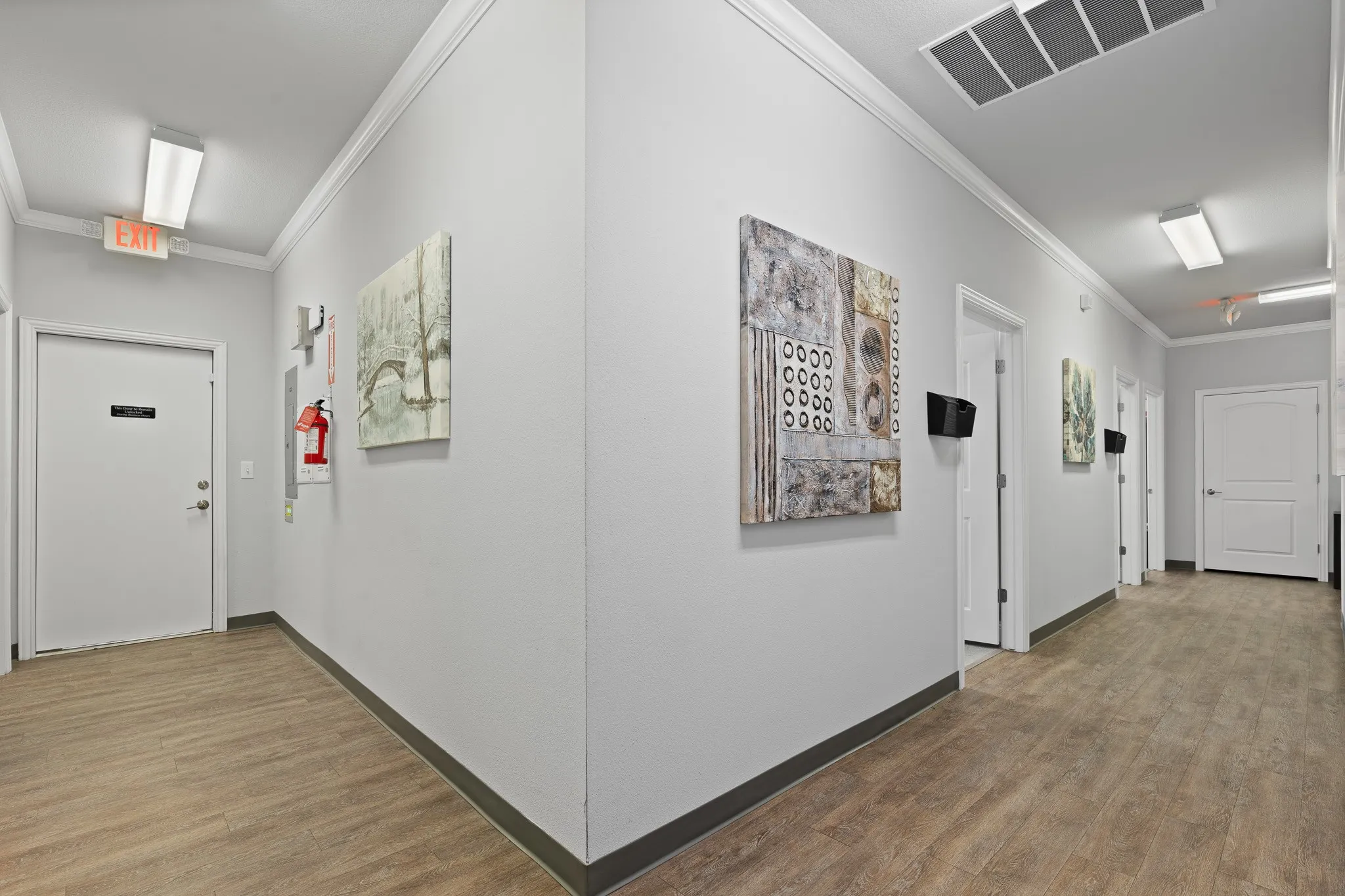 Hallway leading offices and backdoor to the back of property