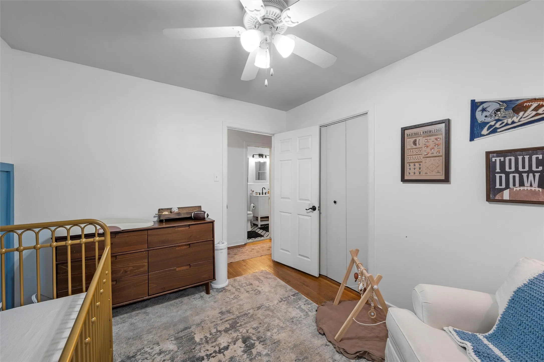 Bedroom featuring dark wood-style flooring, ceiling fan, and a closet