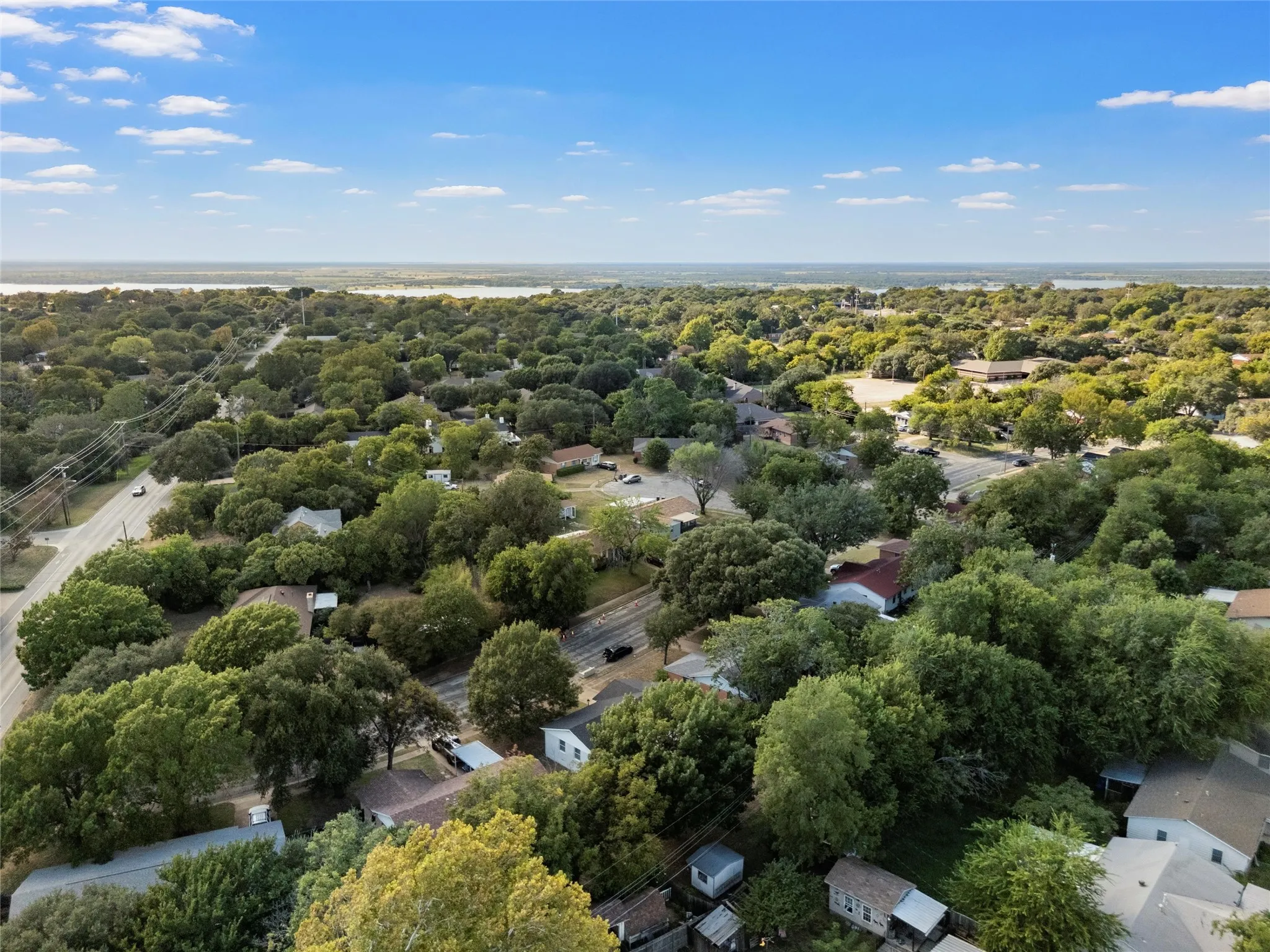 Aerial view of residential area featuring a tree filled landscape