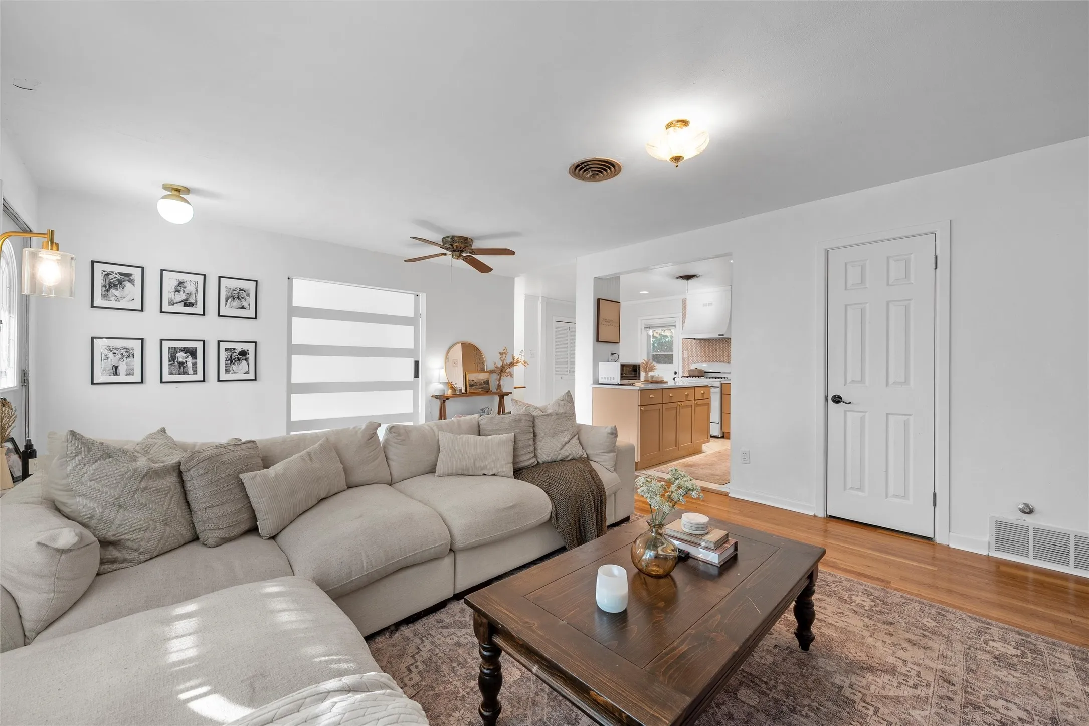 Living room with light wood finished floors and ceiling fan