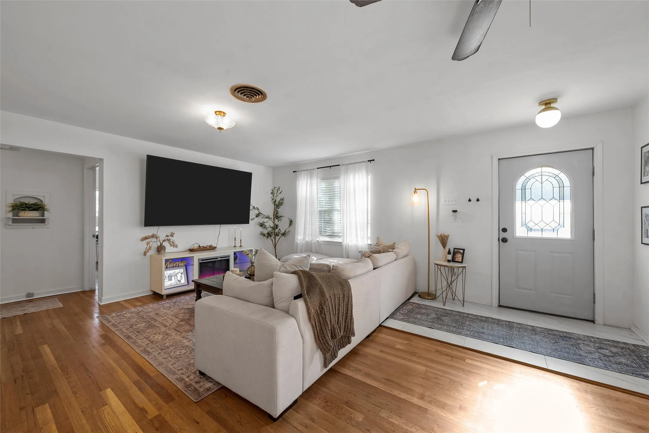 Living area with wood finished floors and ceiling fan