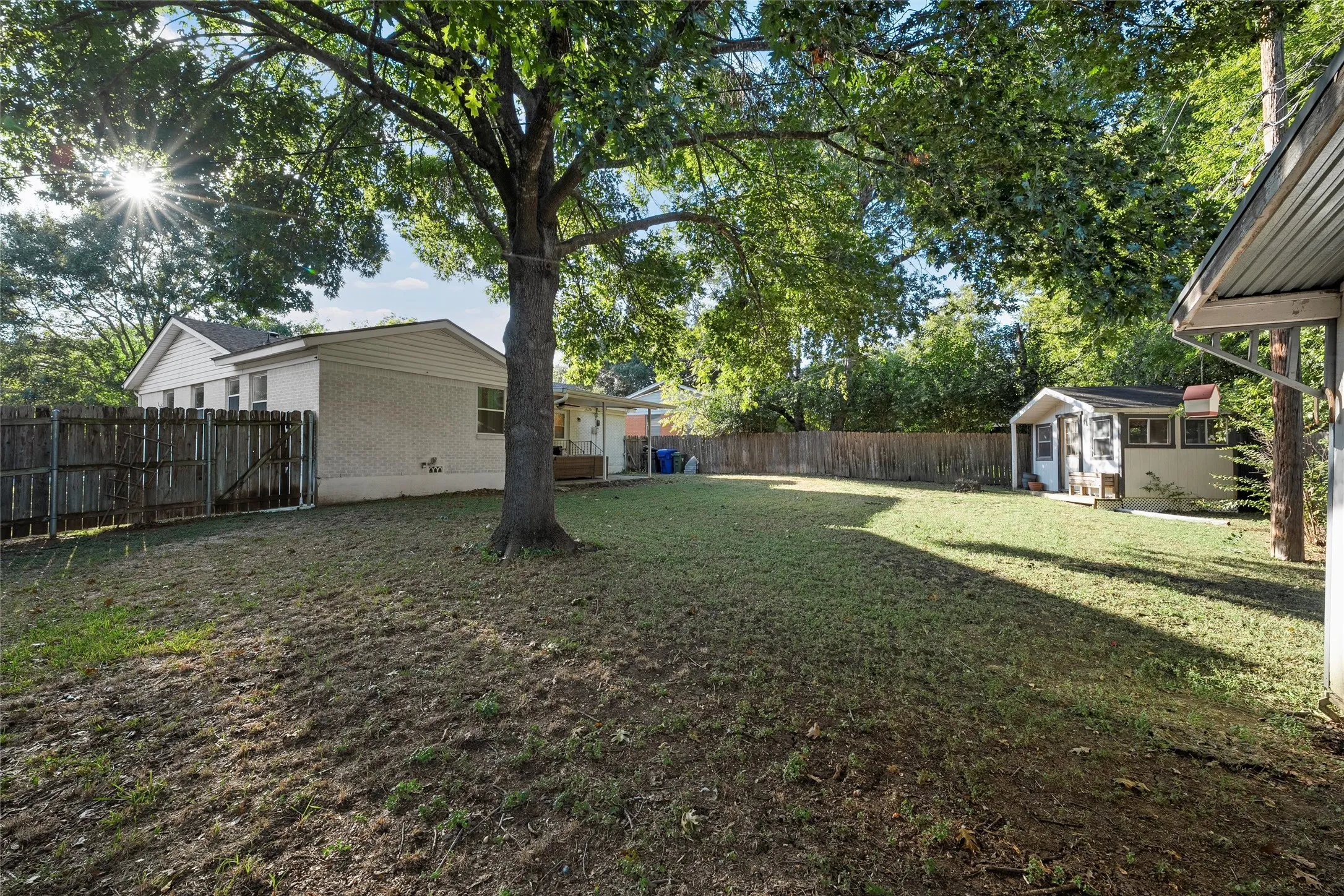 Fenced backyard with a sunroom