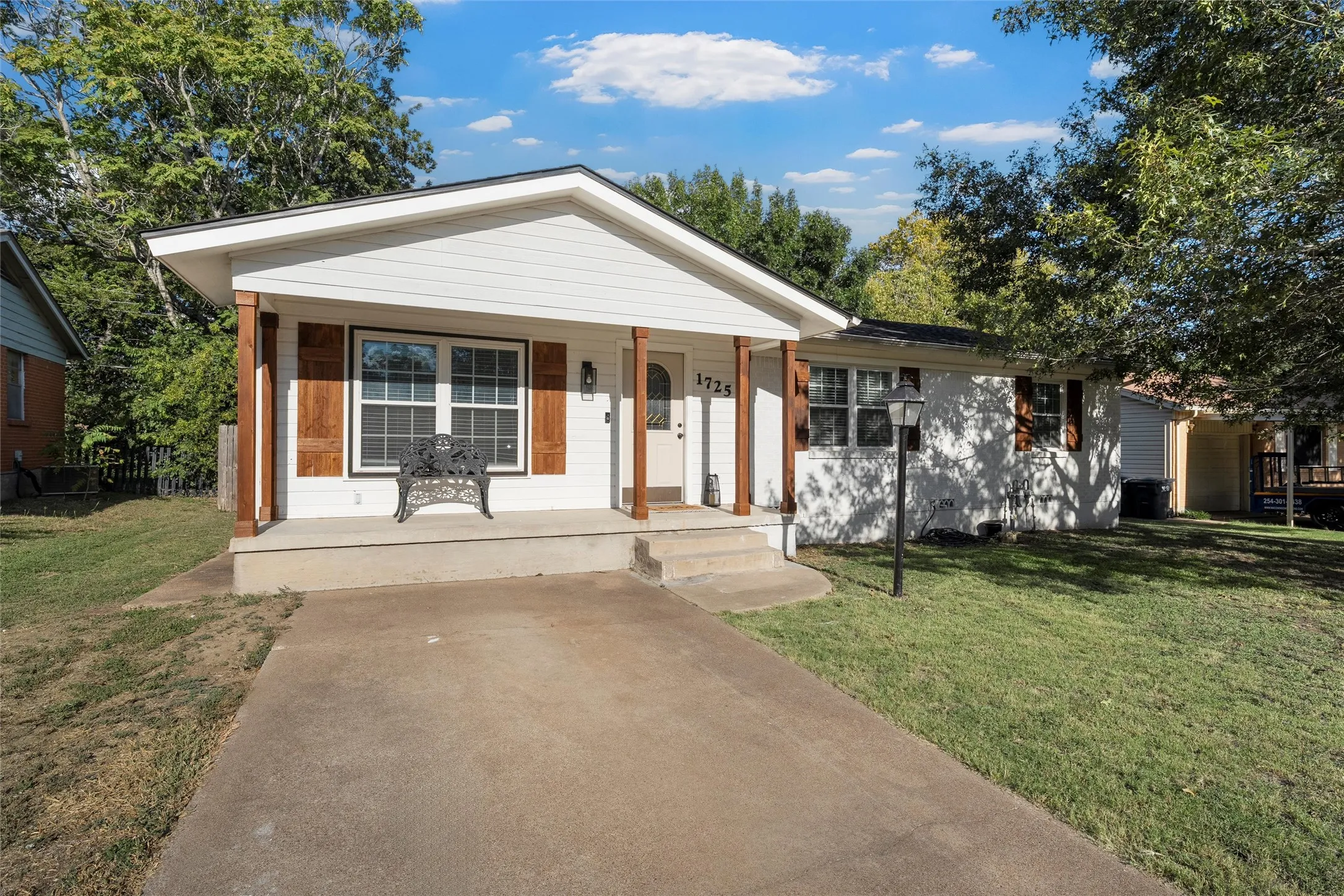 View of front of house with a porch and a front yard