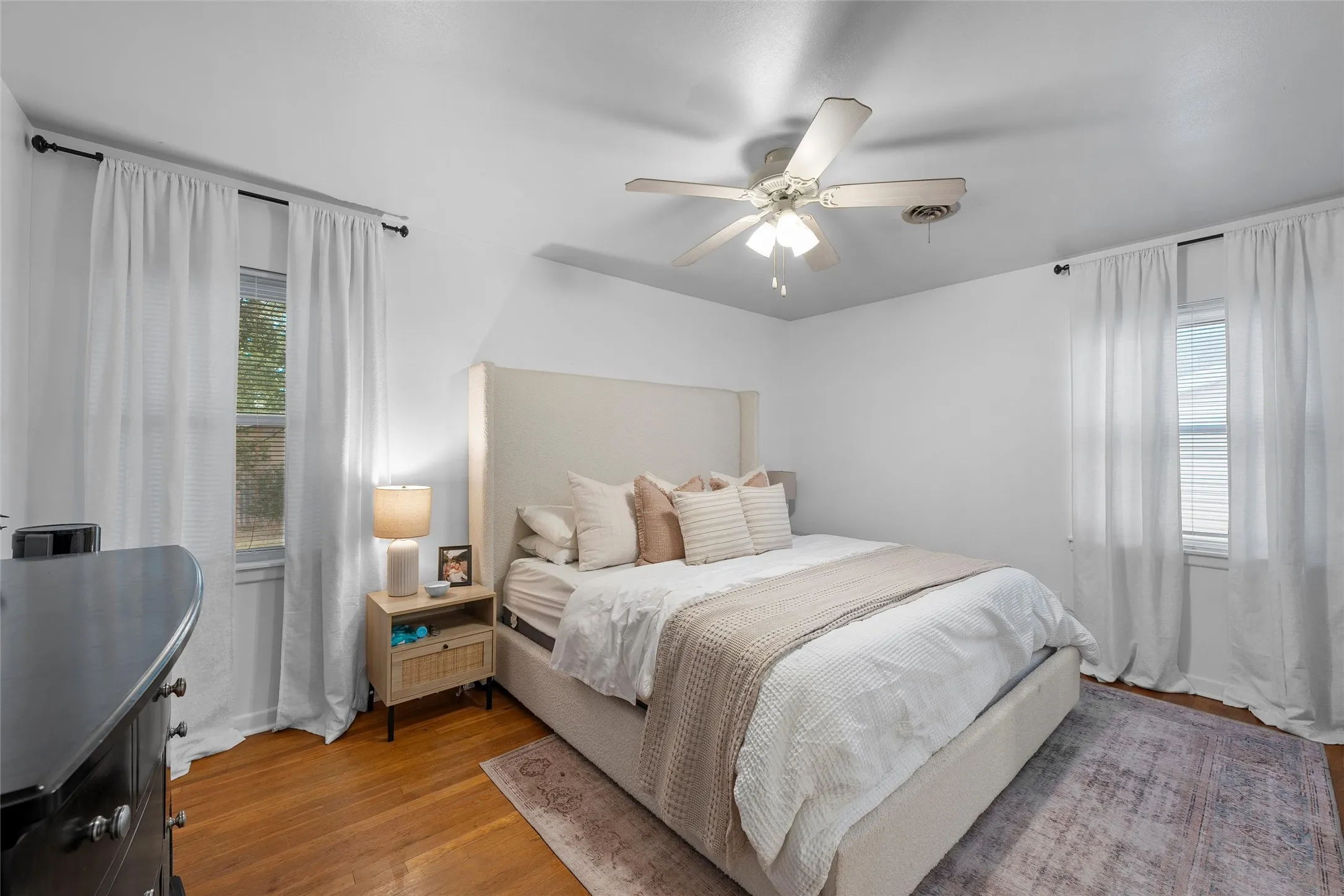 Bedroom featuring wood finished floors and a ceiling fan
