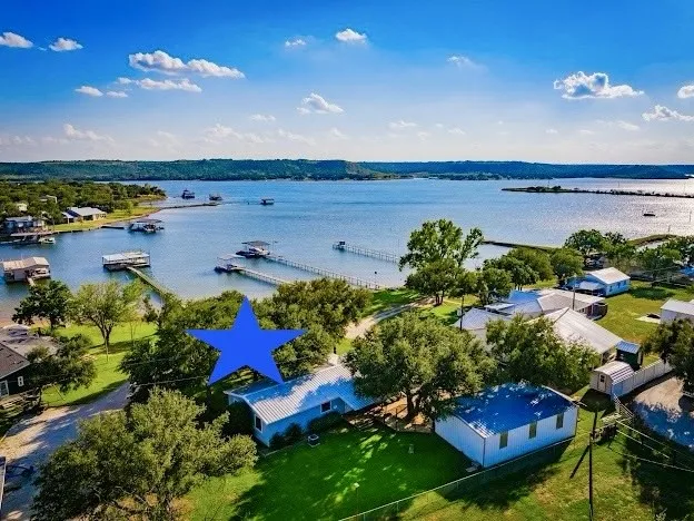 3/2 Lakehouse, with 3 Car Garage and Double Level Dock, all with Panoramic PK Lake Views, Big Grassy Yard and Large Oak Trees for shade.