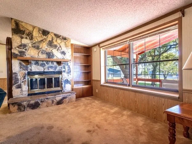 Wood Burning Fireplace and Beautiful Lake Views out the Windows to the Lakeside Porch.