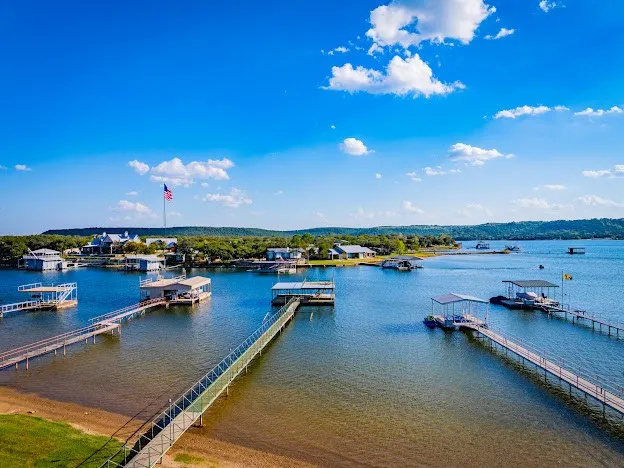 Water is 20' at the Dock but there is also a Sandy Beach at the Shoreline, when the Lake is down a couple feet end of summer.