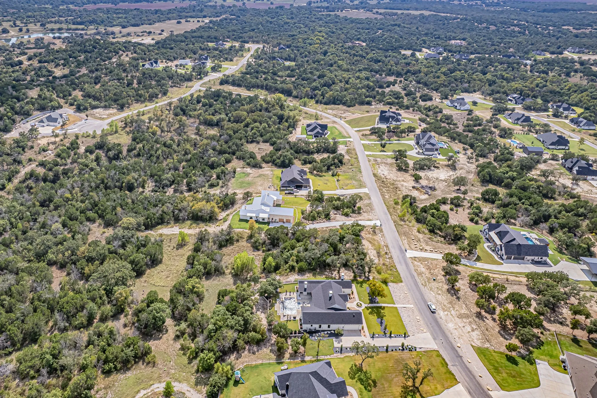 Aerial perspective of suburban area with a tree filled landscape