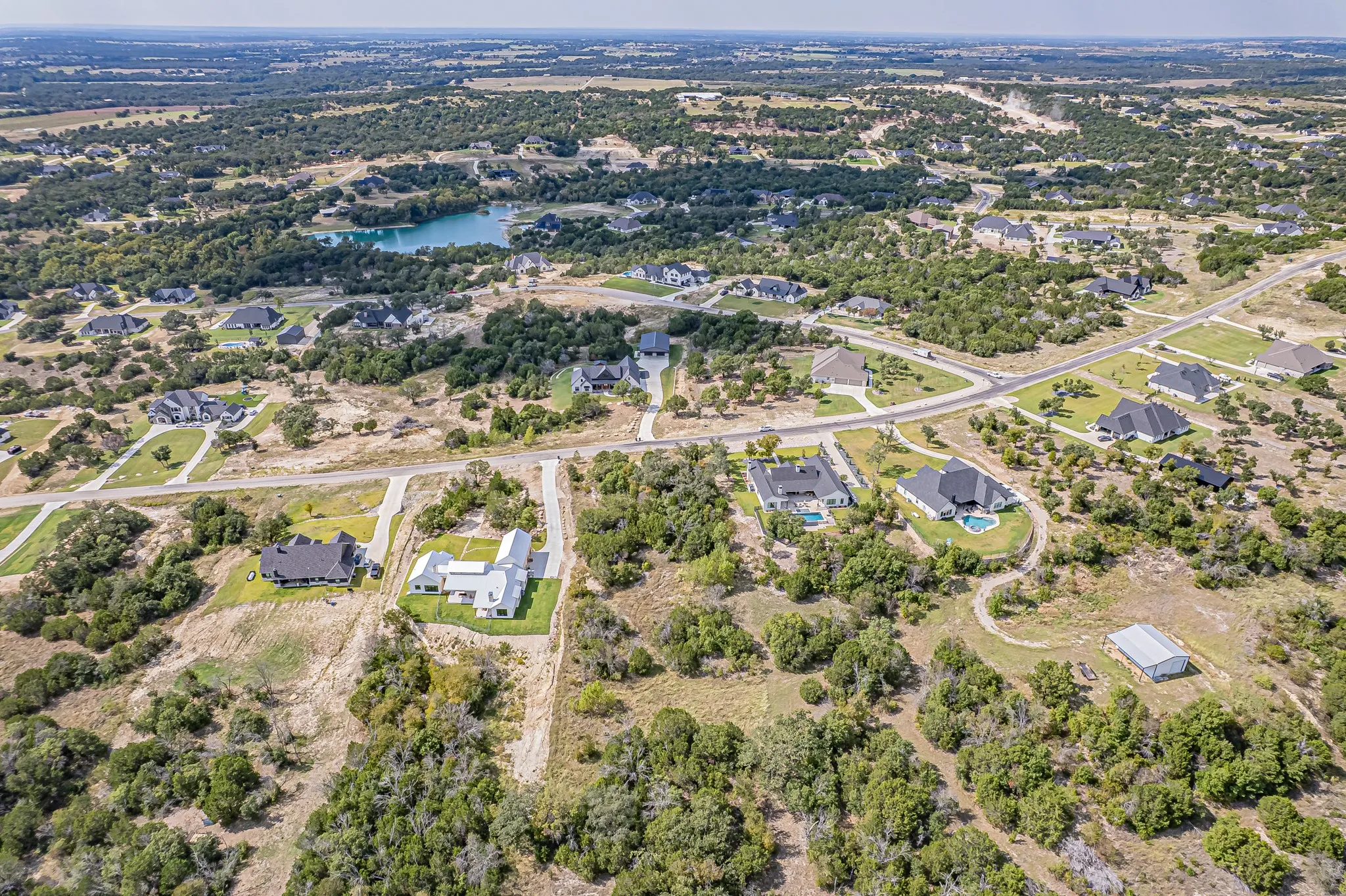 Aerial overview of property's location with nearby suburban area and a nearby body of water