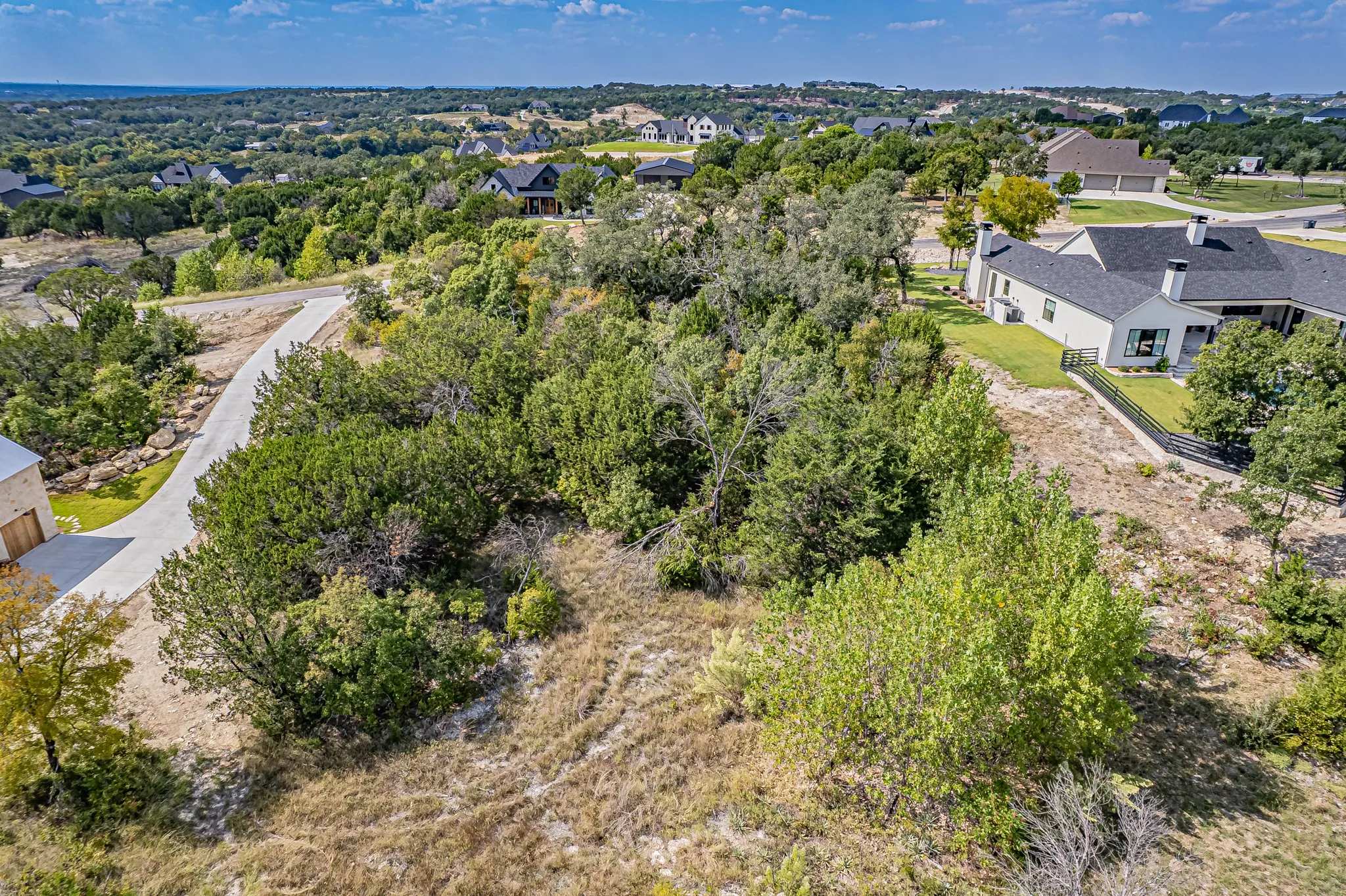 Aerial perspective of suburban area with a tree filled landscape