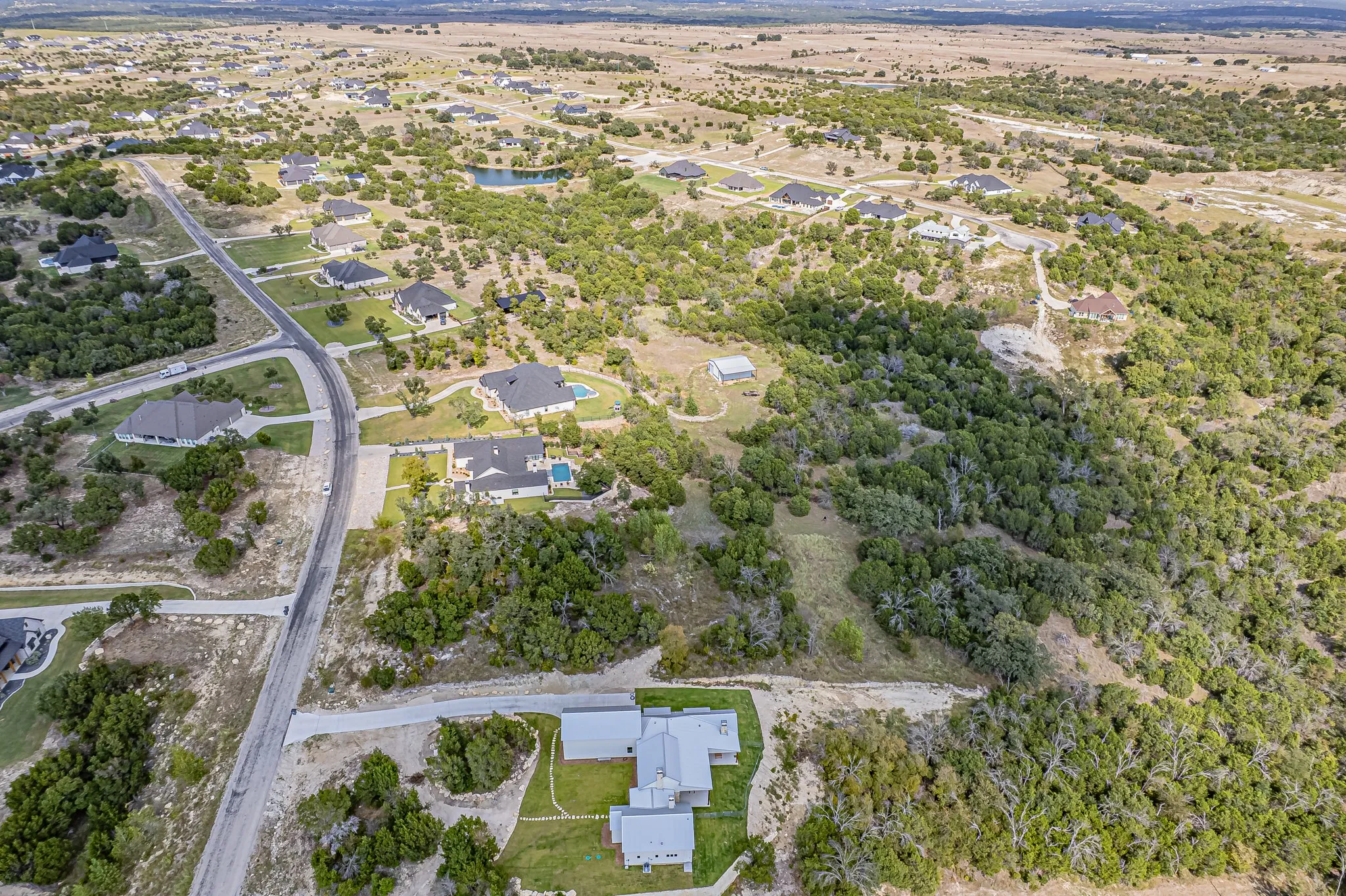 Aerial overview of property's location with nearby suburban area and a nearby body of water